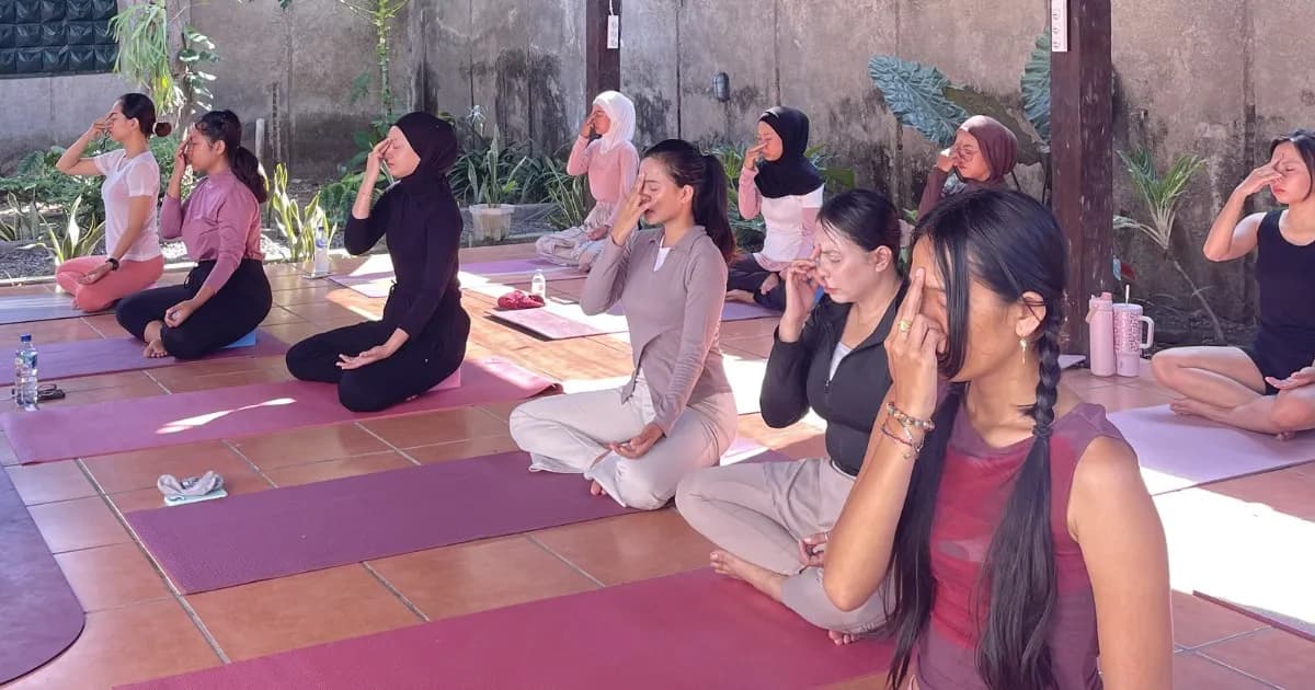 A Nivataa Yoga group class meditating together on a tiled terrace